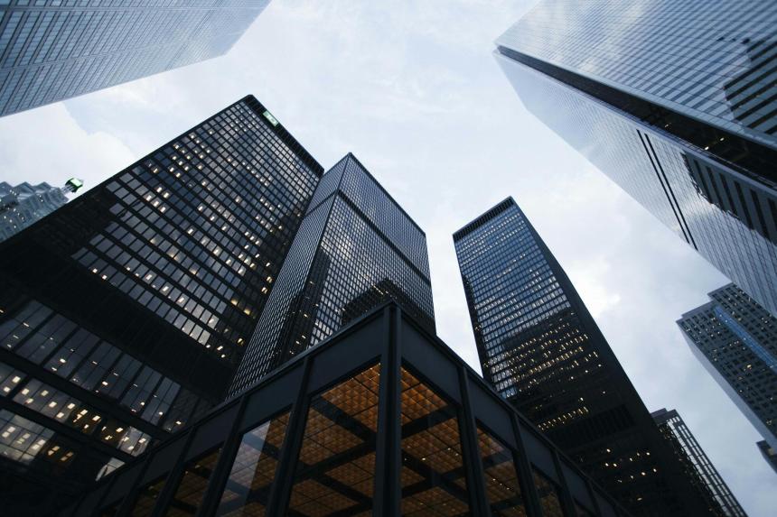 Picture looking up to an overcast sky and tall buildings.